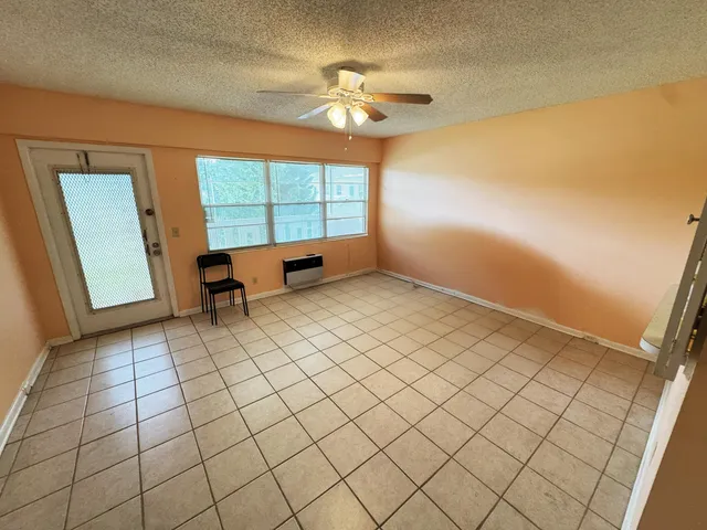 a kitchen with a stove a refrigerator and a cabinets