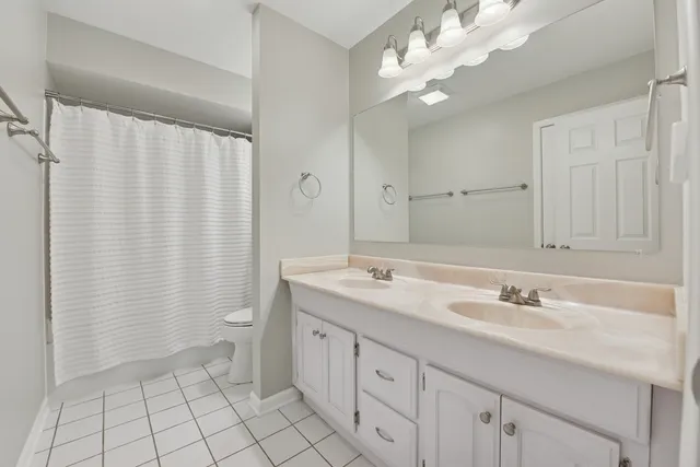 a spacious bathroom with a double vanity sink mirror and