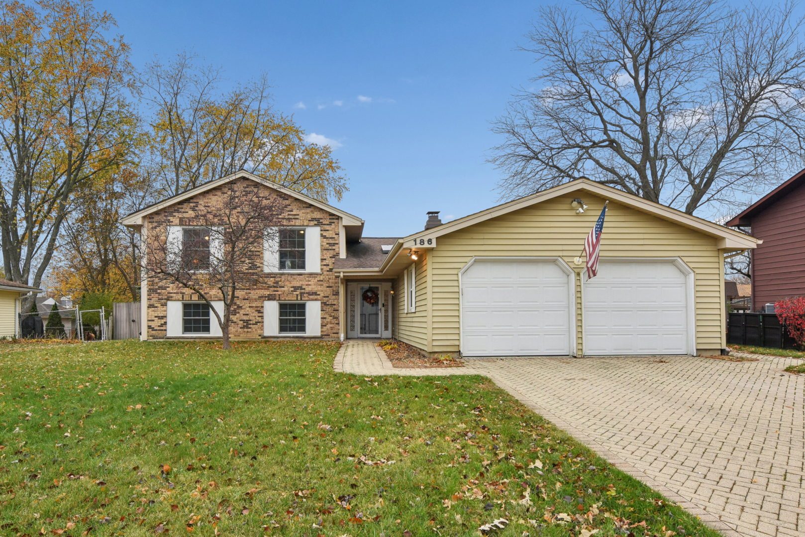 186 Ivy Lane Bloomingdale, IL 60108 - Photo 2 of 38 a front view of house with yard and trees around