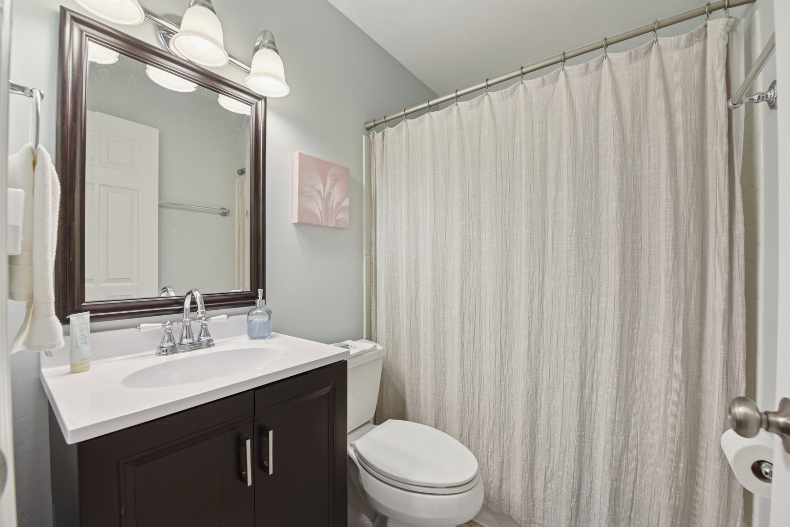 186 Ivy Lane Bloomingdale, IL 60108 - Photo 26 of 38 a bathroom with a sink a toilet a mirror and shower curtain
