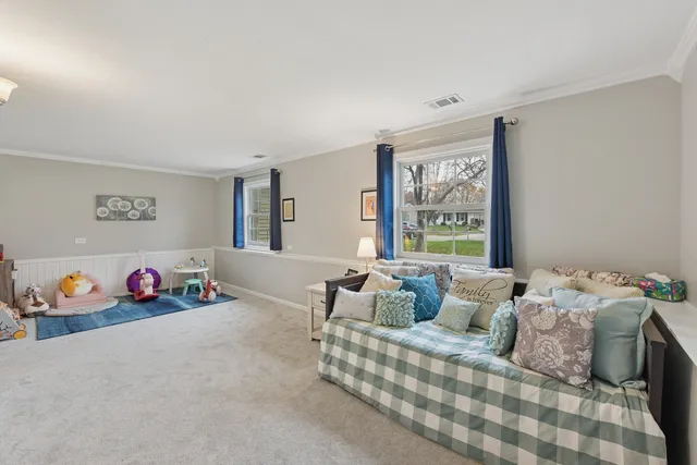 a bedroom with bed and a large window