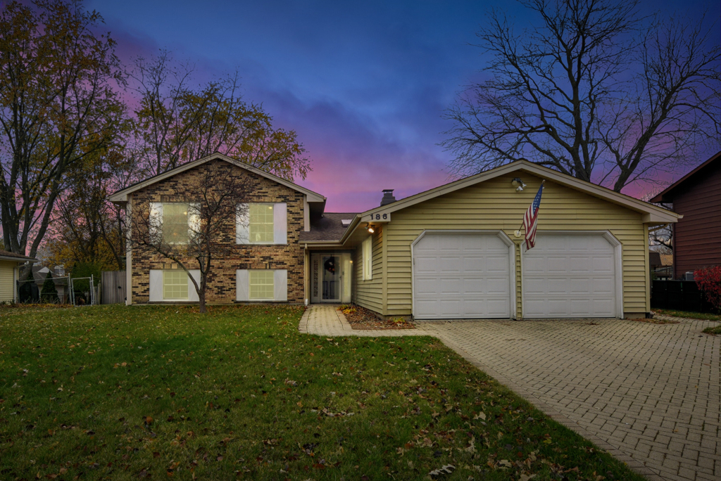 186 Ivy Lane Bloomingdale, IL 60108 - Photo 34 of 38 a front view of a house with a yard and garage