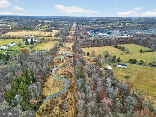 an aerial view of residential houses with outdoor space and river