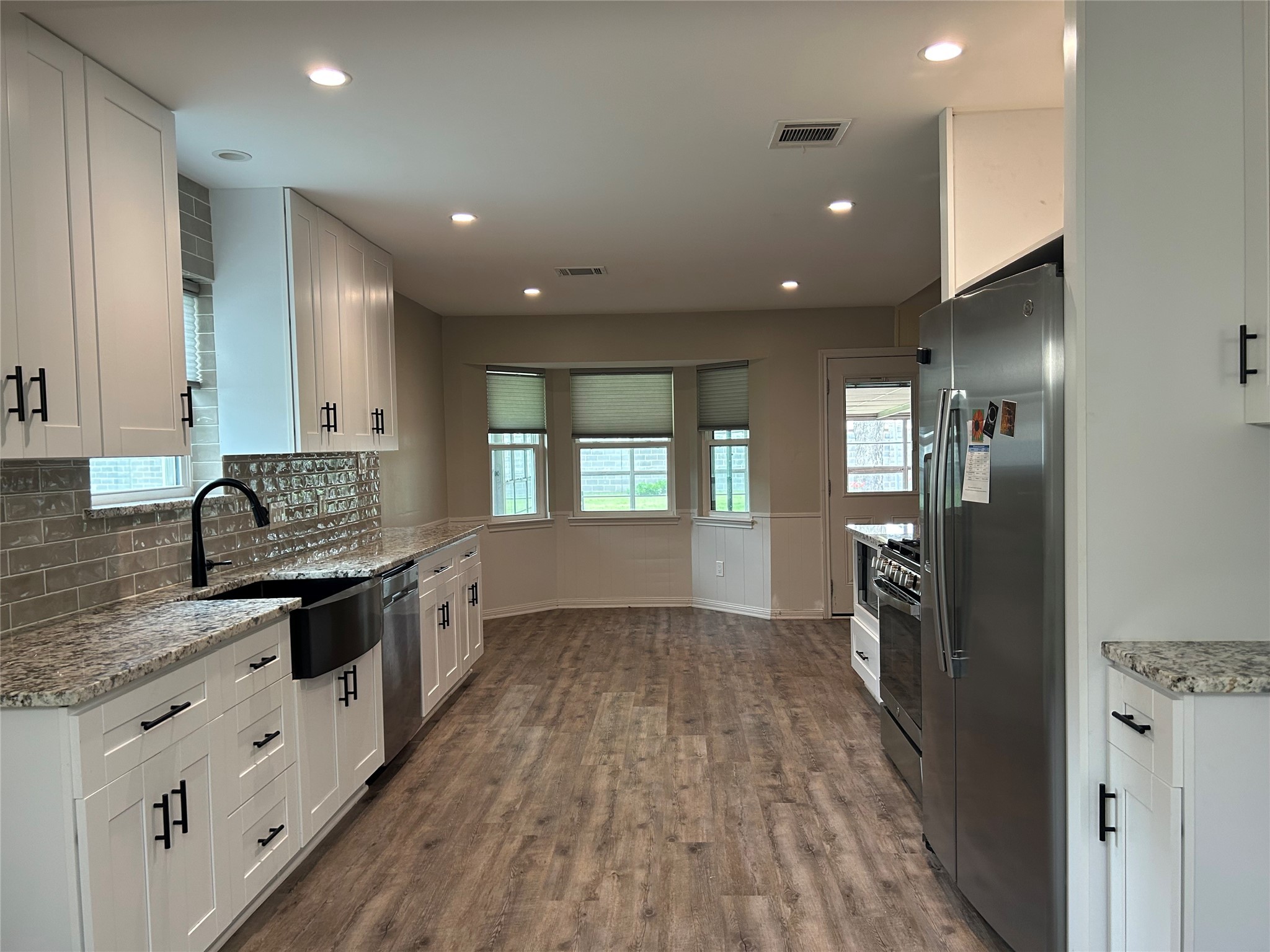 6018 Rena Street Houston, TX 77092 - Photo 12 of 28 a large kitchen with stainless steel appliances granite countertop a refrigerator and a stove