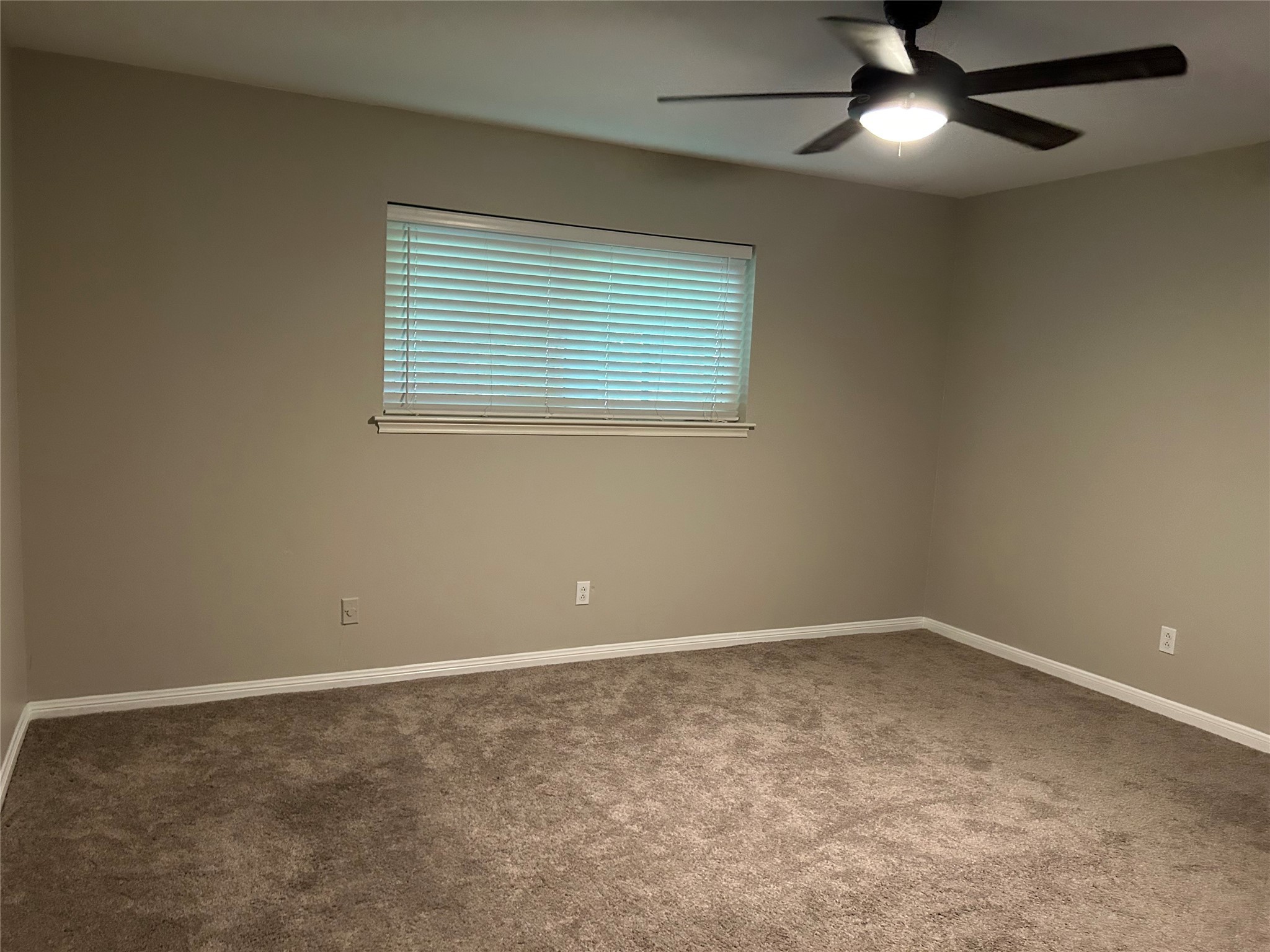 6018 Rena Street Houston, TX 77092 - Photo 16 of 28 an empty room with a window and a fan