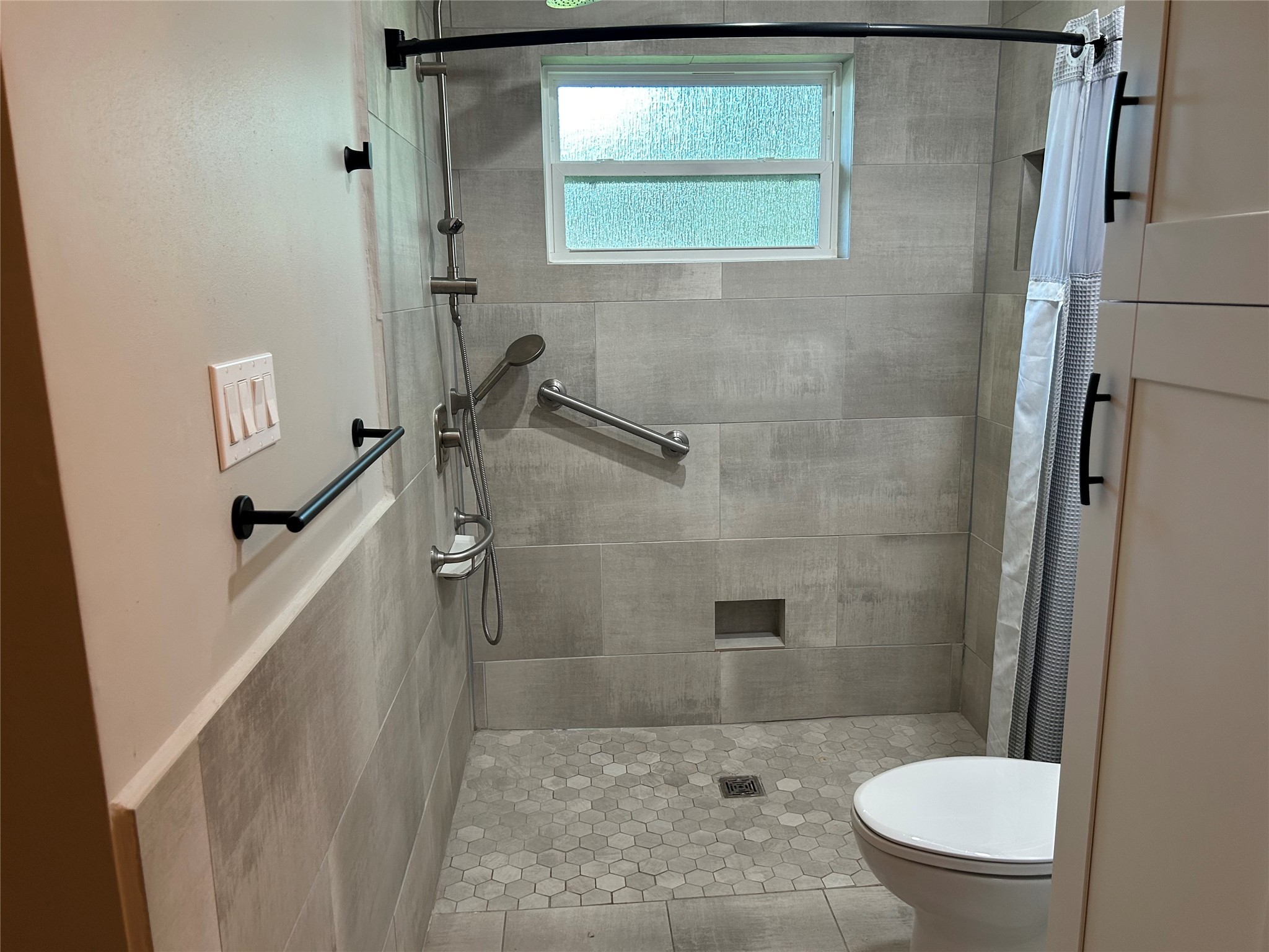 6018 Rena Street Houston, TX 77092 - Photo 17 of 28 a bathroom with a granite countertop shower a toilet and a sink