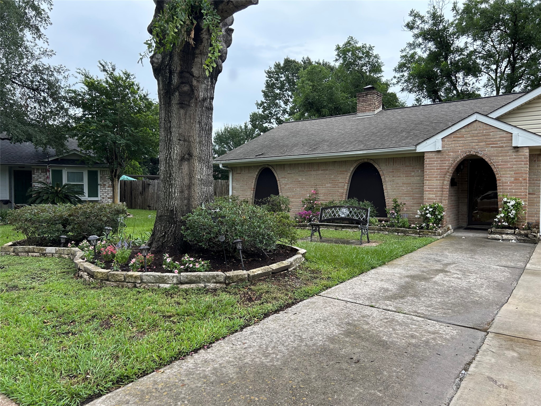 6018 Rena Street Houston, TX 77092 - Photo 23 of 28 a front view of a house with porch and garden