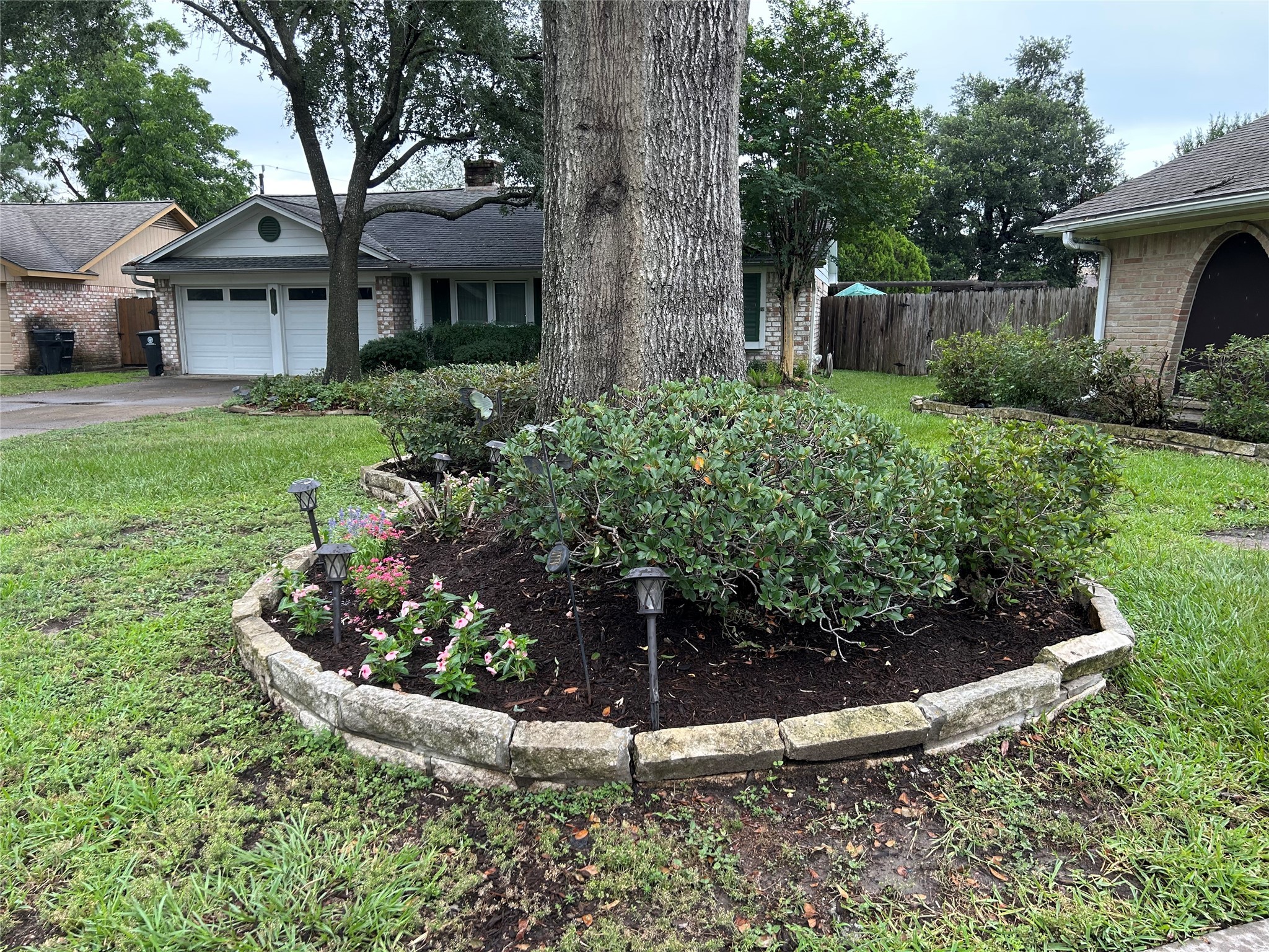 6018 Rena Street Houston, TX 77092 - Photo 24 of 28 a view of a house with a yard and potted plants