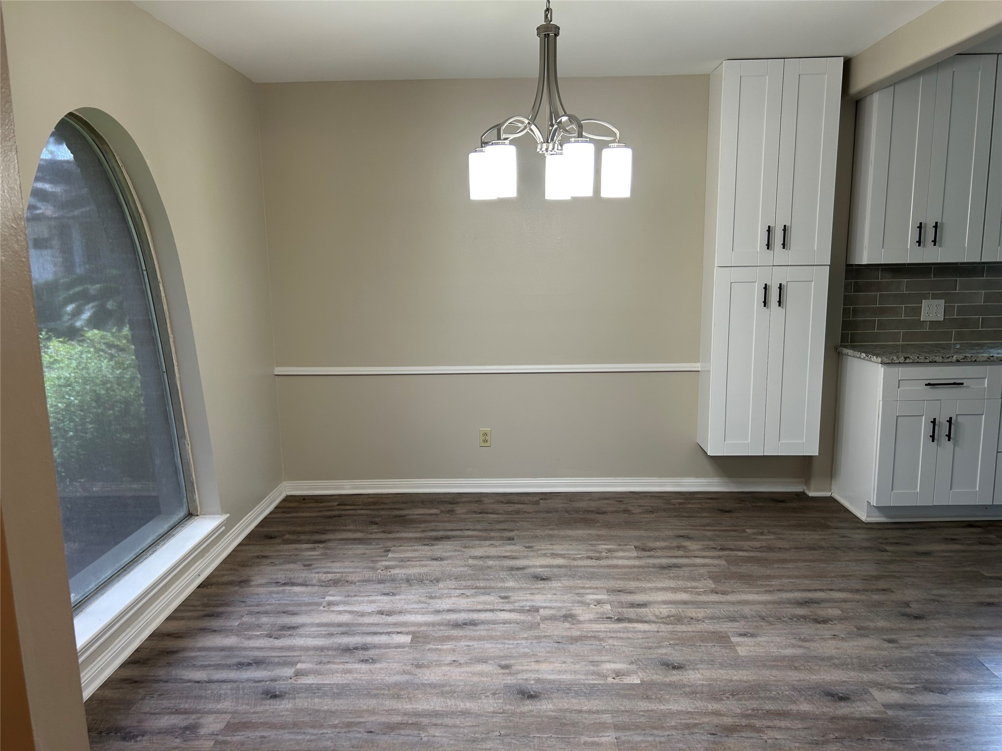 6018 Rena Street Houston, TX 77092 - Photo 8 of 28 an empty room with wooden floor cabinet and windows