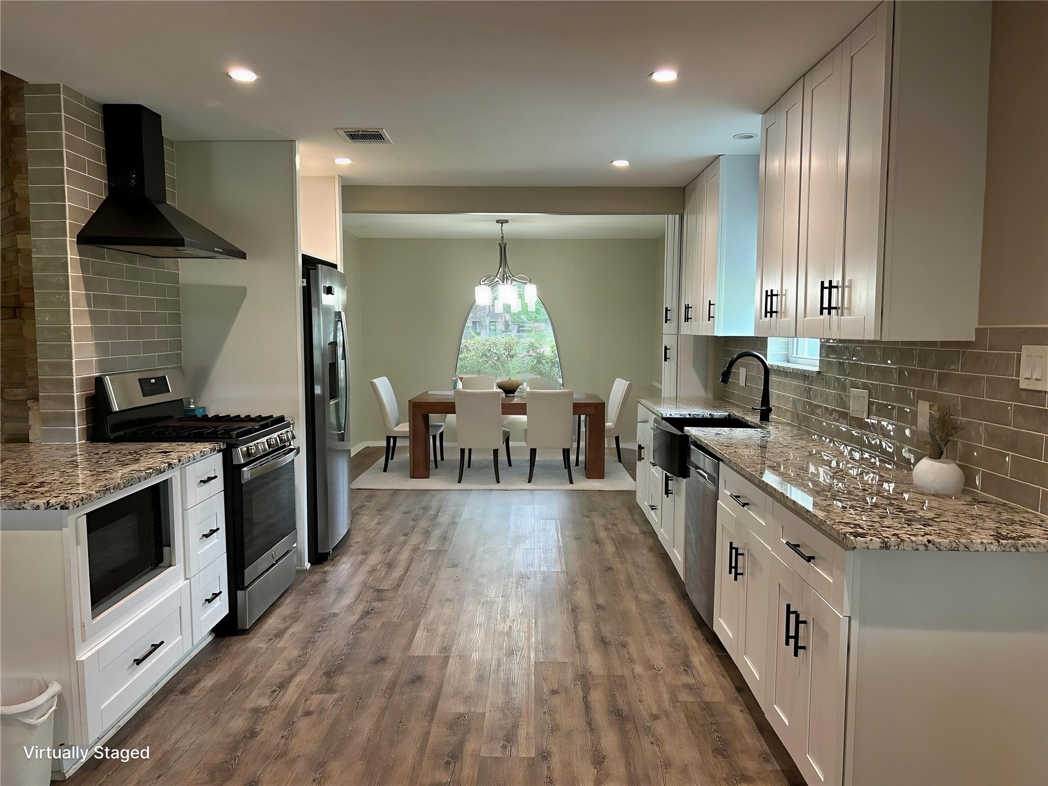 6018 Rena Street Houston, TX 77092 - Photo 9 of 28 a kitchen with stainless steel appliances granite countertop wooden cabinets a stove top oven a sink and dishwasher