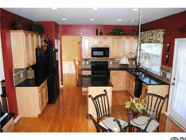 2409 Coltsgate Road Waxhaw, NC 28173 - Photo 2 of 13 a kitchen with stainless steel appliances kitchen island granite countertop a refrigerator a stove top oven a sink and dishwasher