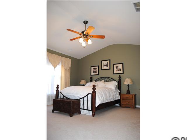 2409 Coltsgate Road Waxhaw, NC 28173 - Photo 5 of 13 a bedroom with a bed and a chandelier