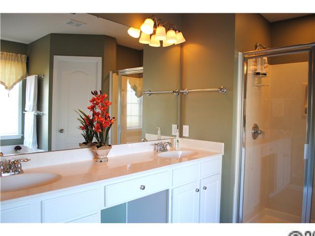 2409 Coltsgate Road Waxhaw, NC 28173 - Photo 6 of 13 a bathroom with a sink and a mirror