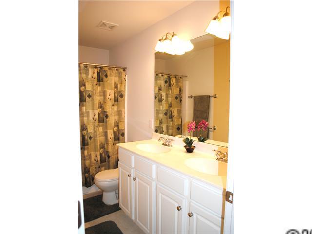 2409 Coltsgate Road Waxhaw, NC 28173 - Photo 9 of 13 a bathroom with a sink a toilet and a mirror