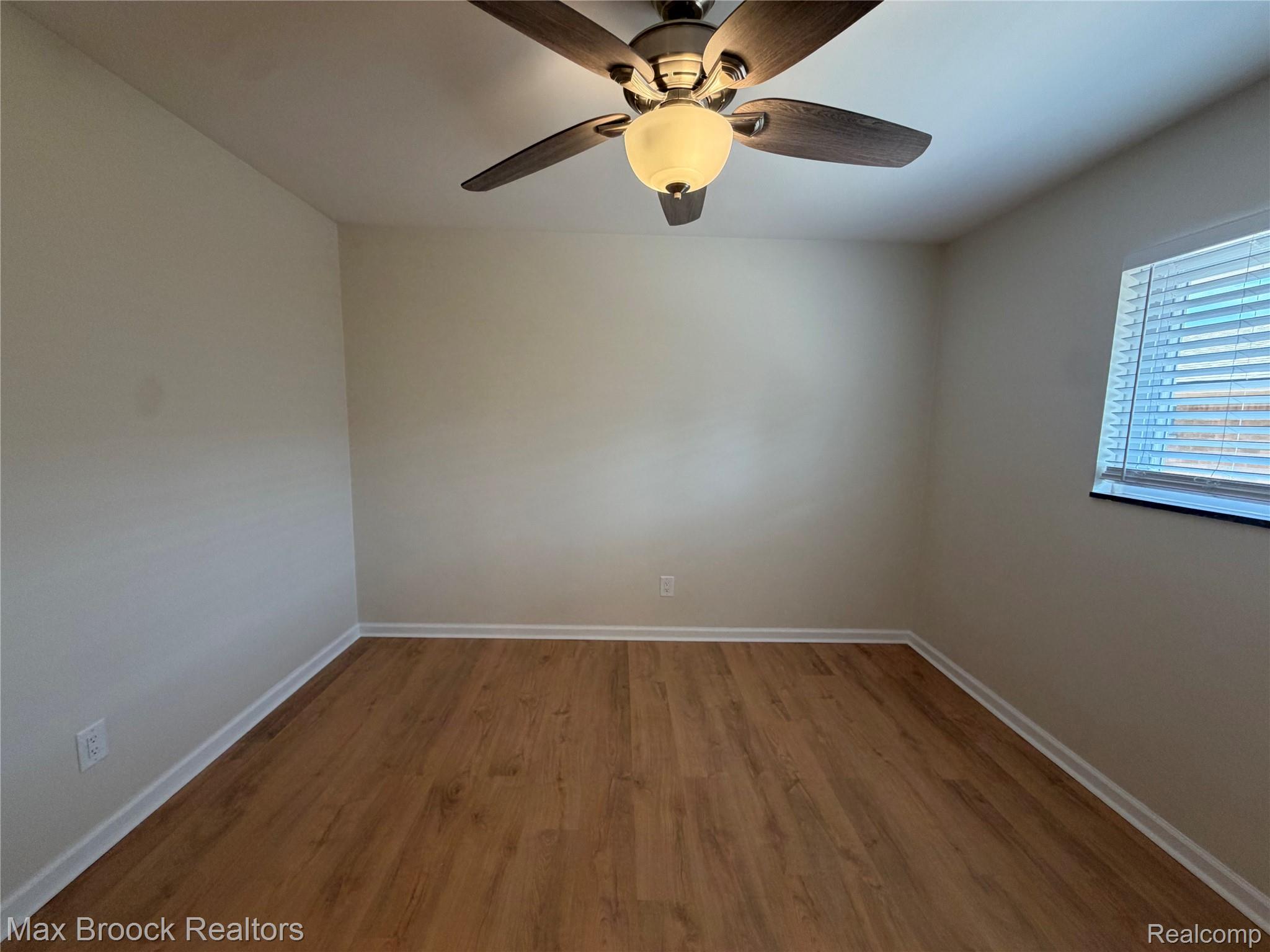 3875 Devon Road, Unit # 9 Royal Oak, MI 48073 - Photo 9 of 17 Wood-finish flooring with white baseboards