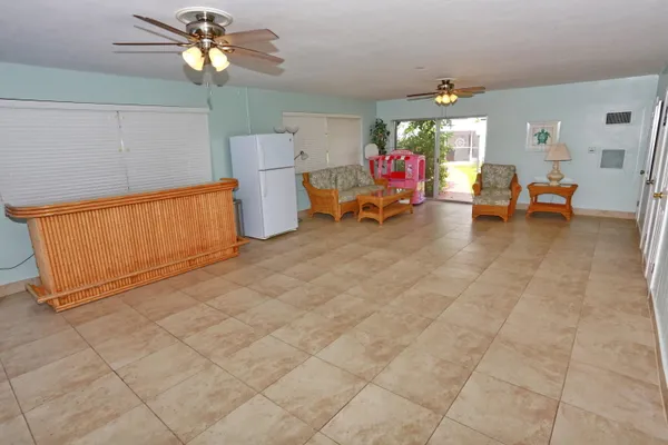 a view of a livingroom with furniture and a window