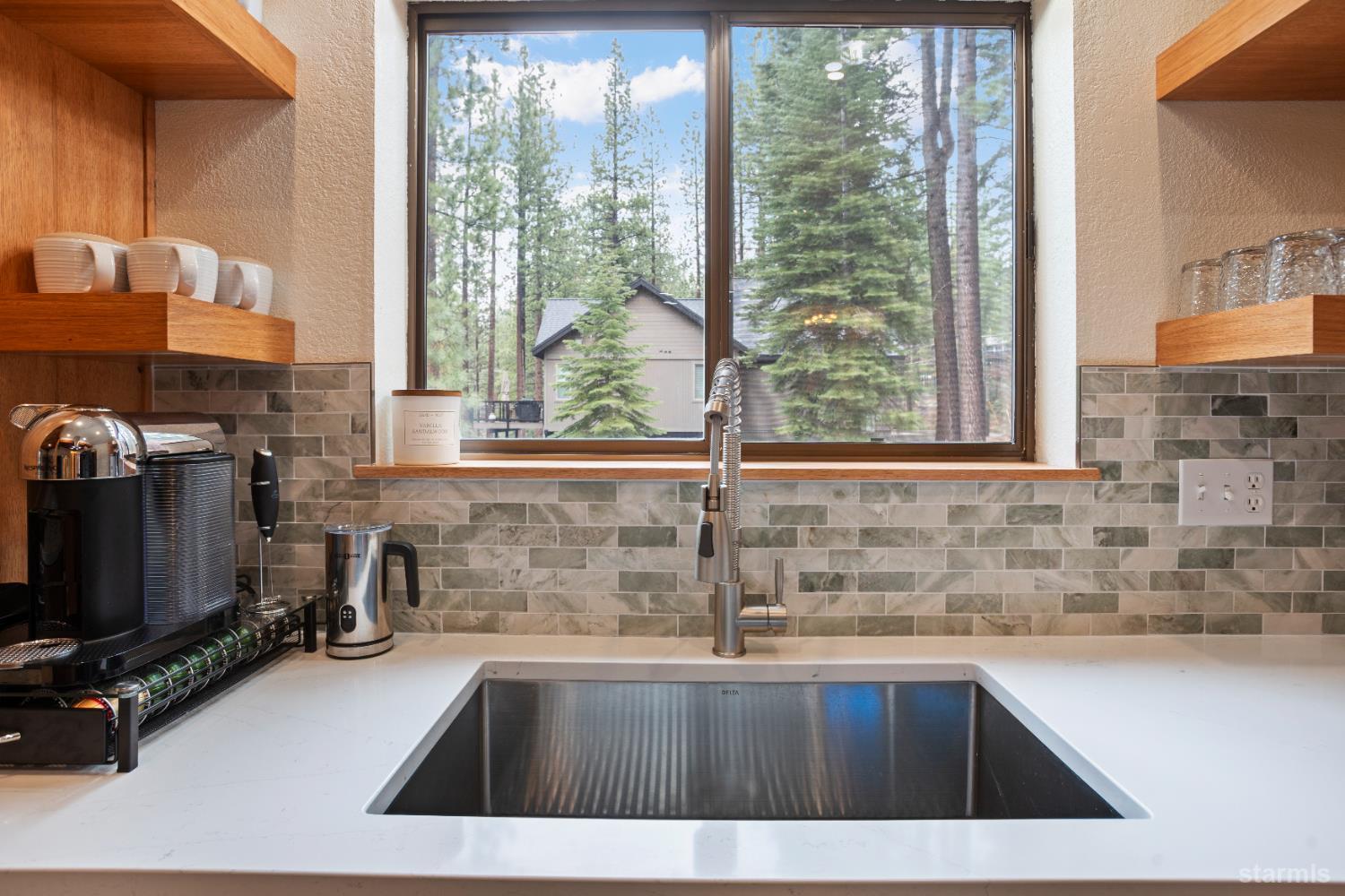 1408 Pebble Beach Road South Lake Tahoe, CA 96150 - Photo 16 of 34 a view of a kitchen with a sink and dishwasher next to a window