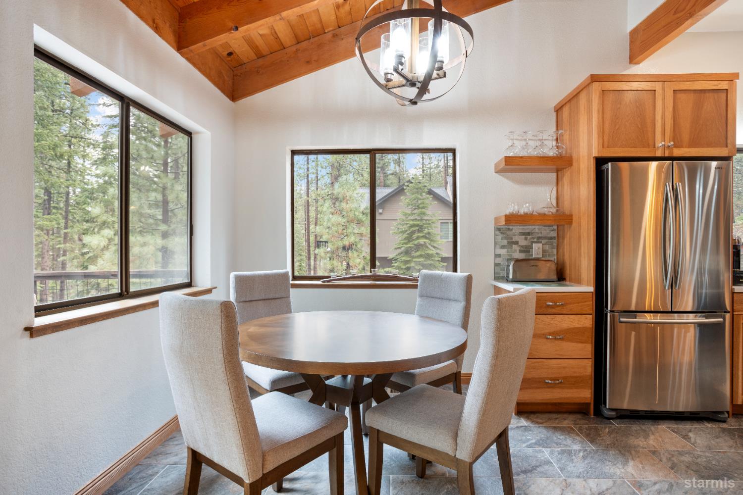 1408 Pebble Beach Road South Lake Tahoe, CA 96150 - Photo 17 of 34 a dining room with furniture a chandelier and wooden floor