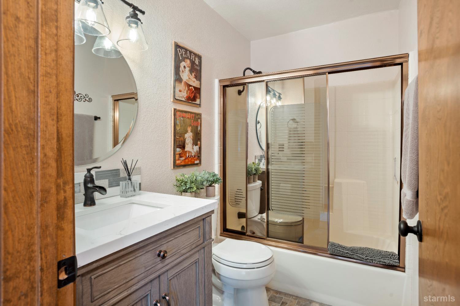 1408 Pebble Beach Road South Lake Tahoe, CA 96150 - Photo 21 of 34 a bathroom with a shower sink vanity mirror and toilet
