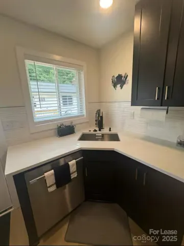 a kitchen with a sink a stove and cabinets