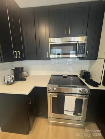 a stove top oven sitting inside of a kitchen