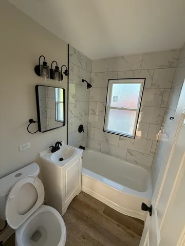 a bathroom with a toilet sink and mirror