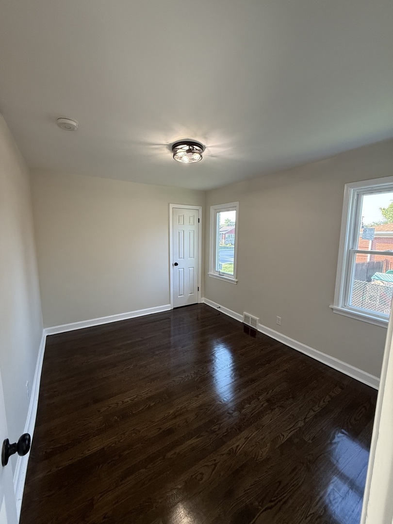 18351 Dixie Highway Homewood, IL 60430 - Photo 5 of 11 a view of an empty room with wooden floor and a window