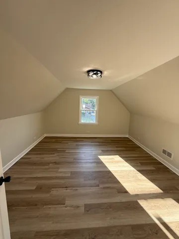 a view of an empty room and wooden floor