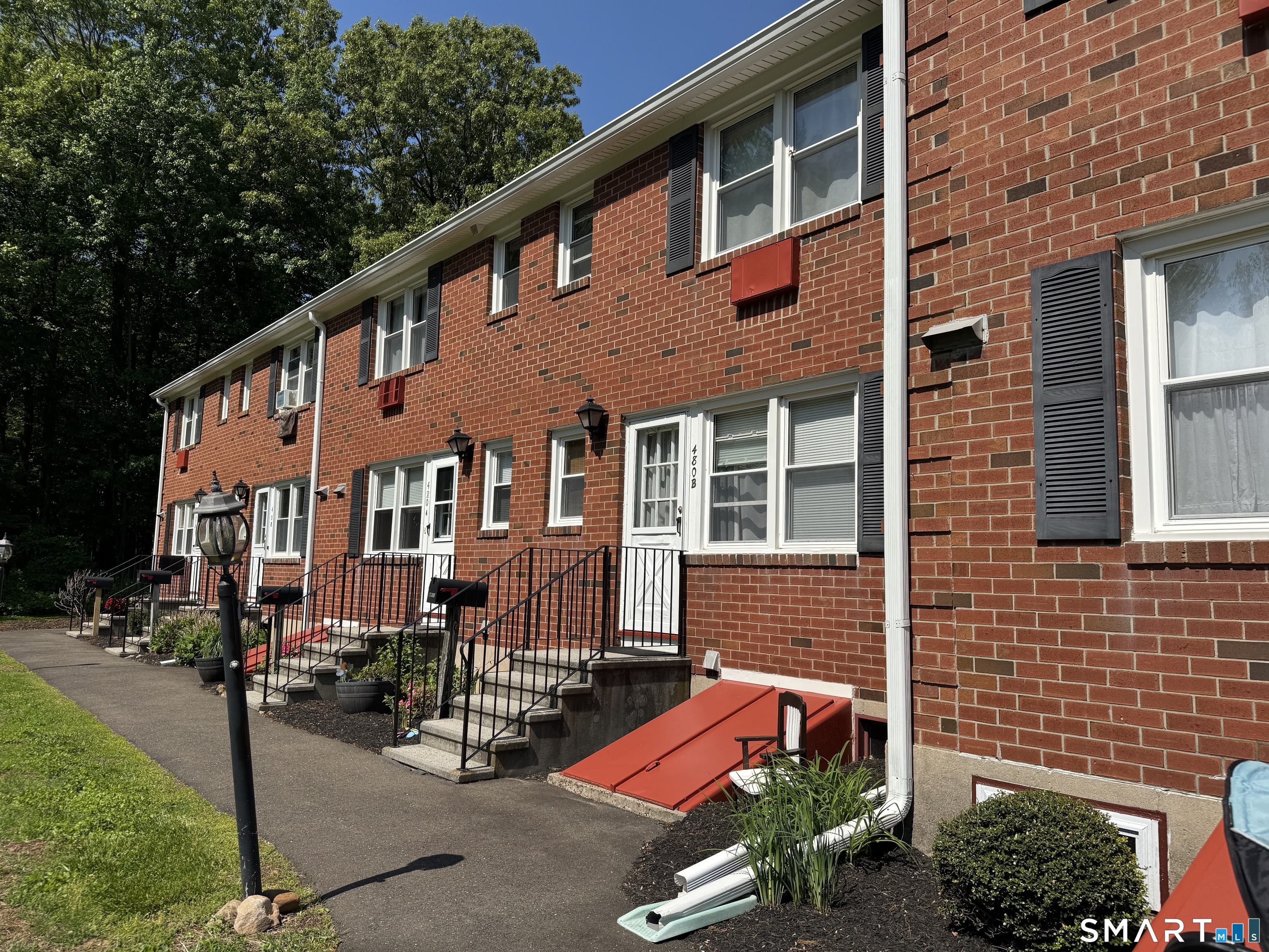 480 Radmere Road, Unit B Cheshire, CT 06410 - Photo 2 of 13 a front view of a building with sitting area