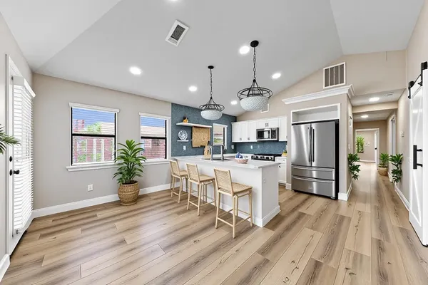 a view of a dining room with furniture wooden floor and chandelier