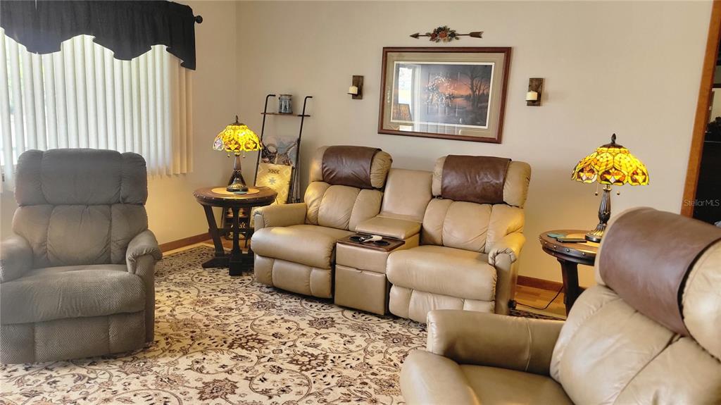 7858 Southwest 112th Lane Ocala, FL 34476 - Photo 2 of 25 a living room with furniture and a couch