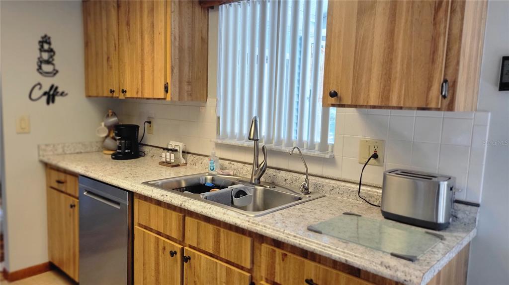 7858 Southwest 112th Lane Ocala, FL 34476 - Photo 4 of 25 a kitchen with a sink cabinets and window