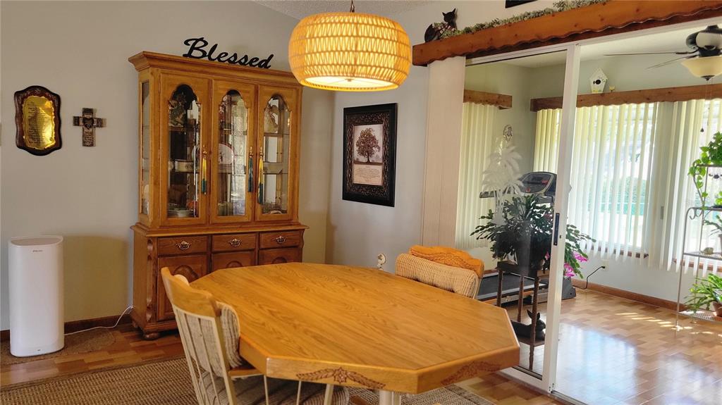 7858 Southwest 112th Lane Ocala, FL 34476 - Photo 5 of 25 a bedroom with a bed and dresser with wooden floor