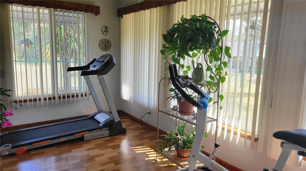 7858 Southwest 112th Lane Ocala, FL 34476 - Photo 7 of 25 a room with potted plants and a large window