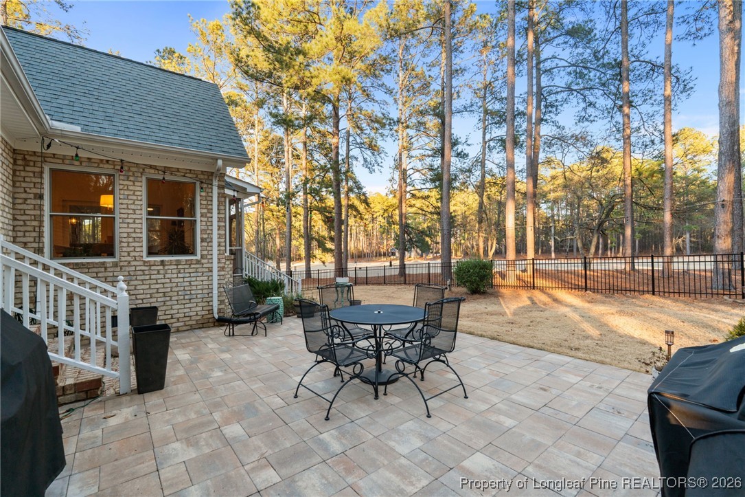 30181 East Lake Road Wagram, NC 28396 - Photo 13 of 38 a view of a patio with table and chairs and potted plants