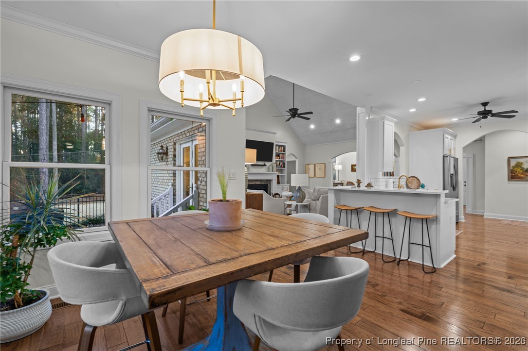 30181 East Lake Road Wagram, NC 28396 - Photo 18 of 38 a living room with stainless steel appliances kitchen island a table and chairs in it