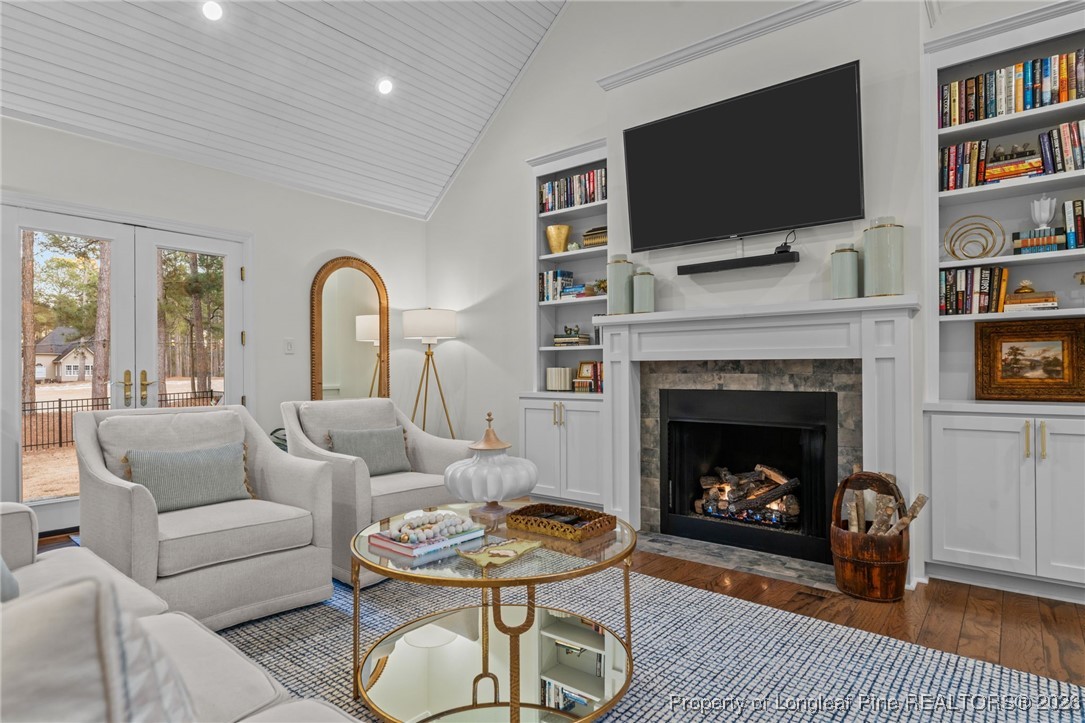 30181 East Lake Road Wagram, NC 28396 - Photo 22 of 38 a living room with furniture a flat screen tv and a fireplace