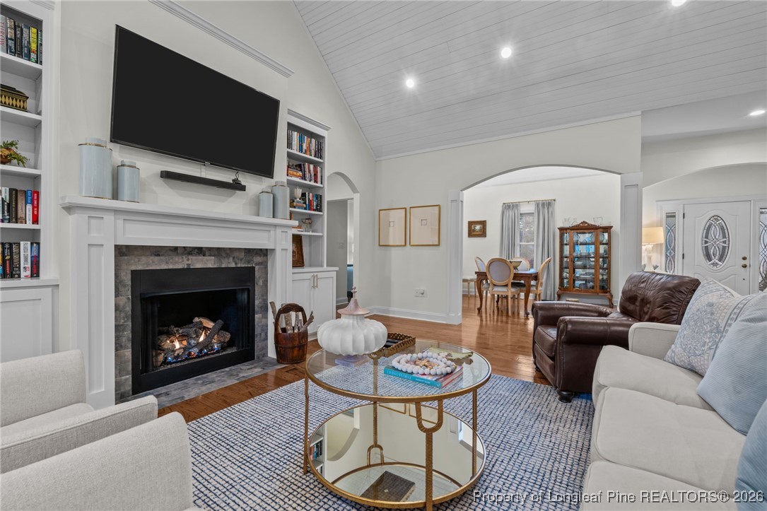 30181 East Lake Road Wagram, NC 28396 - Photo 24 of 38 a living room with furniture a flat screen tv and a fireplace