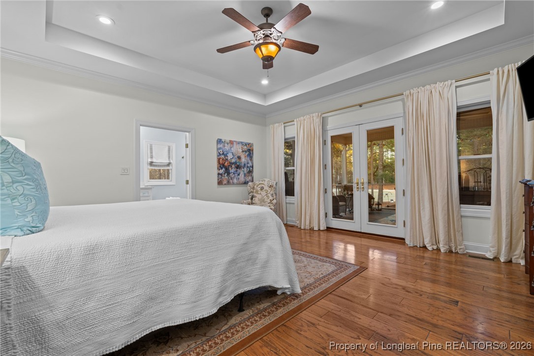 30181 East Lake Road Wagram, NC 28396 - Photo 28 of 38 a spacious bedroom with a bed and a chandelier
