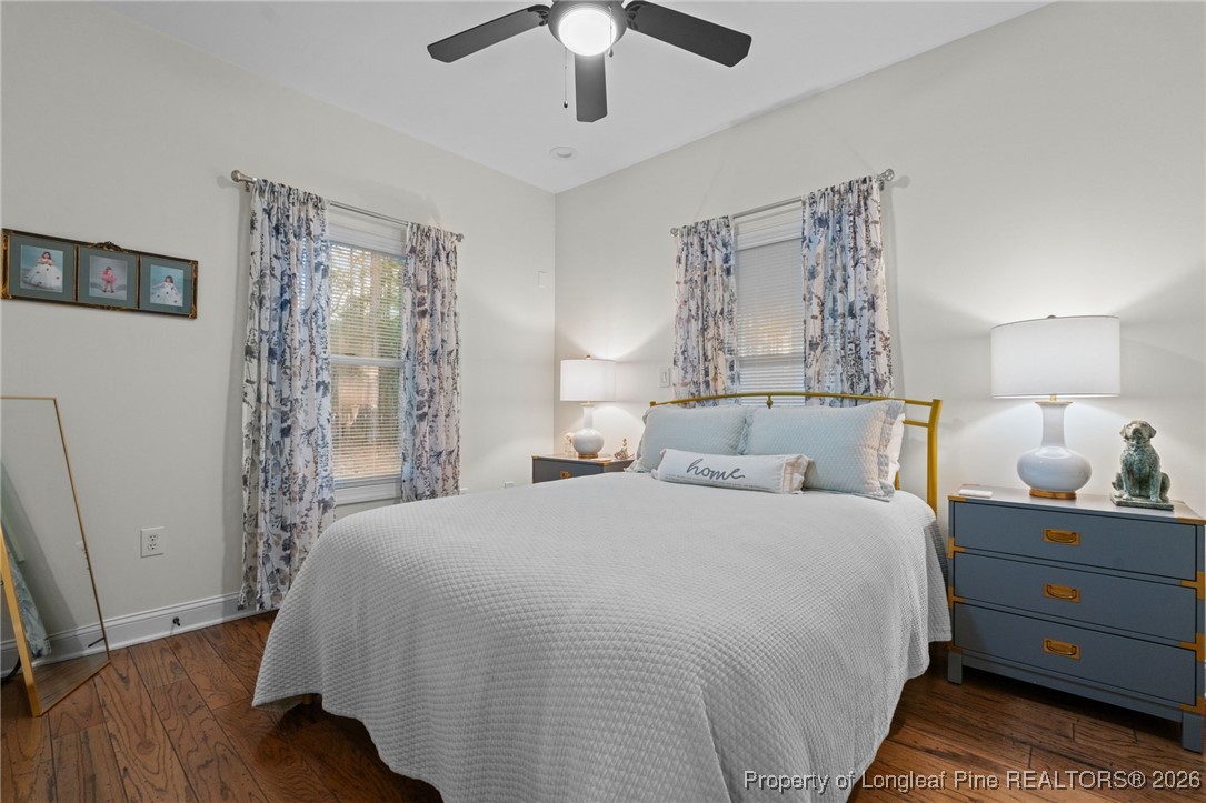 30181 East Lake Road Wagram, NC 28396 - Photo 32 of 38 a bedroom with a bed and a chandelier