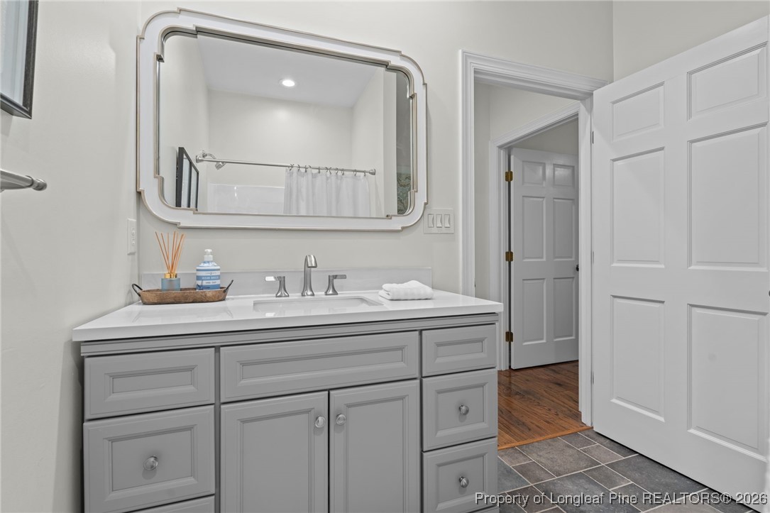 30181 East Lake Road Wagram, NC 28396 - Photo 33 of 38 a bathroom with a sink and a mirror