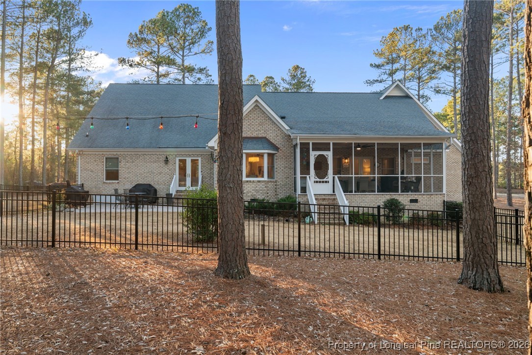 30181 East Lake Road Wagram, NC 28396 - Photo 9 of 38 a view of a house with a fence and a yard