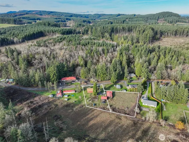 an aerial view of a chairs and table on the side of the road