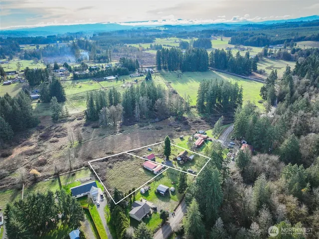 an aerial view of residential houses with outdoor space and lake view