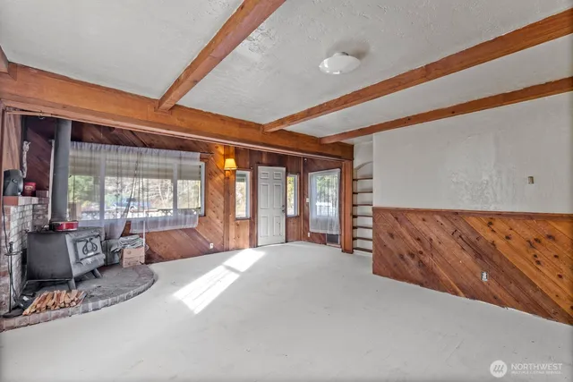 a spacious bedroom with a large bed and large windows