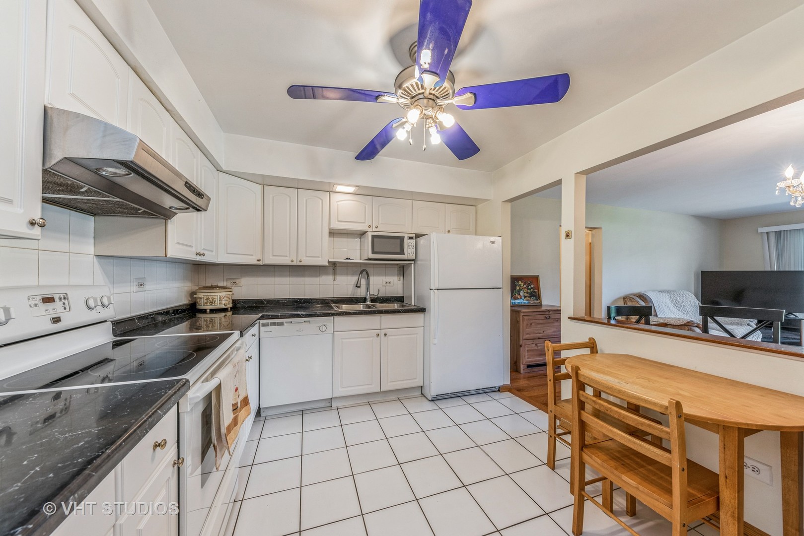 2222 South Goebbert Road, Unit 159 Arlington Heights, IL 60005 - Photo 6 of 15 a kitchen with stove cabinets and chandelier