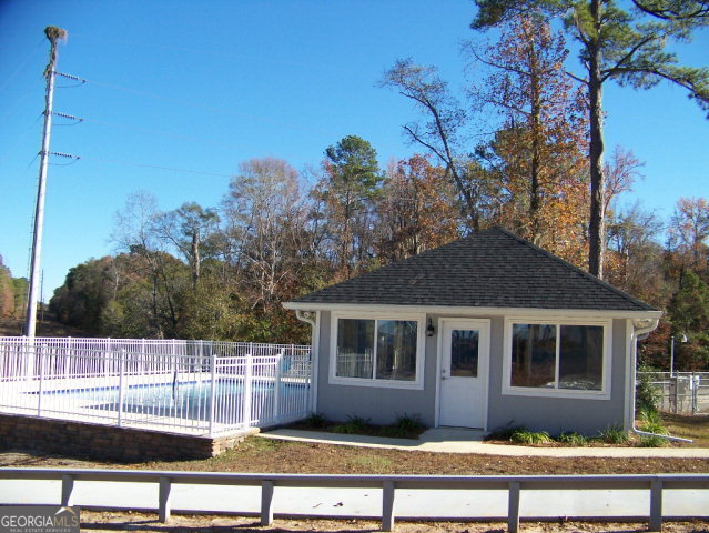 0 Point Drive, Unit LOT 2 3 4 Georgetown, GA 39854 - Photo 4 of 9 a front view of a house with a garden and swimming pool