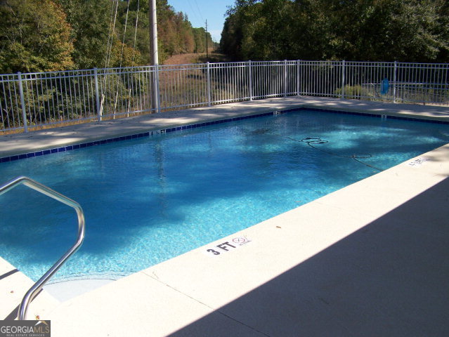 0 Point Drive, Unit LOT 2 3 4 Georgetown, GA 39854 - Photo 6 of 9 a view of a swimming pool with a balcony