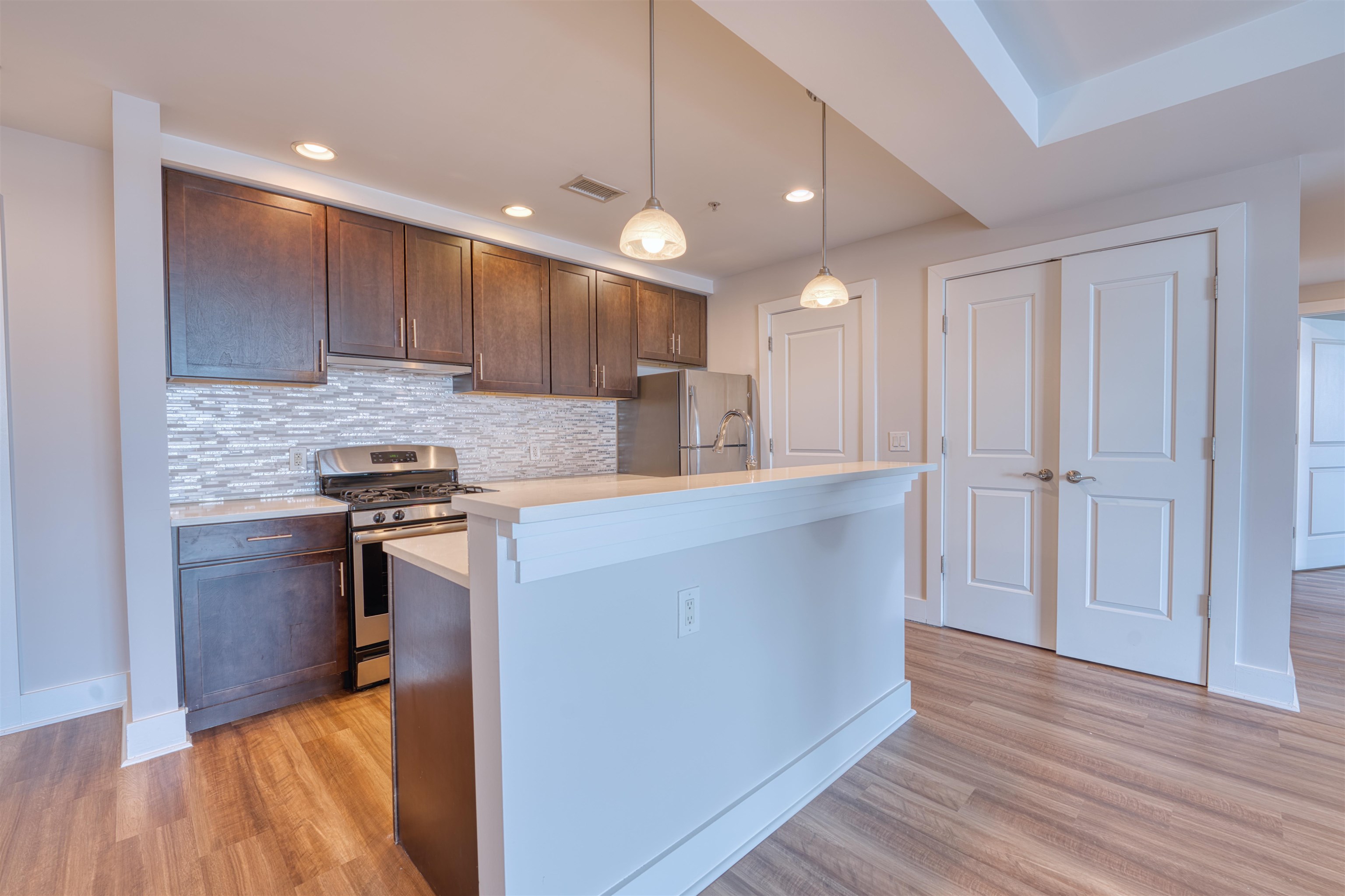 a kitchen with kitchen island granite countertop wooden cabinets and a sink