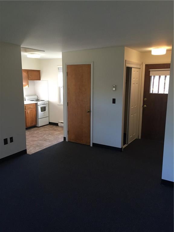 a view of a kitchen with wooden floor and windows